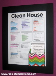 A framed weekly cleaning chart with colorful chore cards