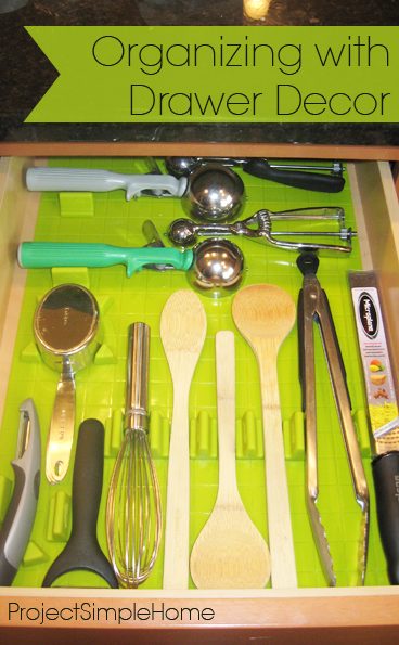 An organized kitchen utensil drawer on a lime green liner